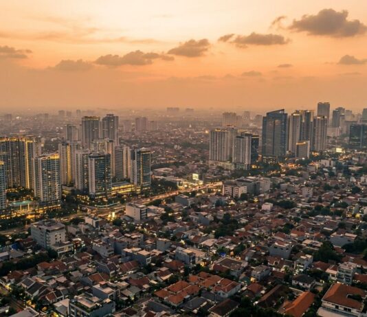 Harga Properti Jakarta Tidak Akan Pernah Turun — Ini Alasannya Skyline Jakarta dari udara menggambarkan tren harga properti yang terus naik secara struktural — analisis Panduanproperti.id